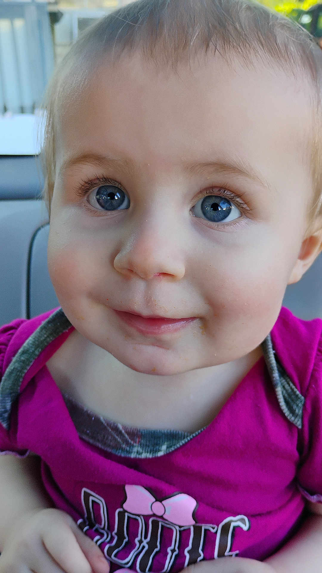 Nevaeh is registered to the contest to win money with this photo: toddler, child, face, blue_eyes, smile, close_up, magenta_shirt, bow, cute, portrait, young_child, skin, hair, eyelashes, expression, sitting, indoors, person, baby, clothing