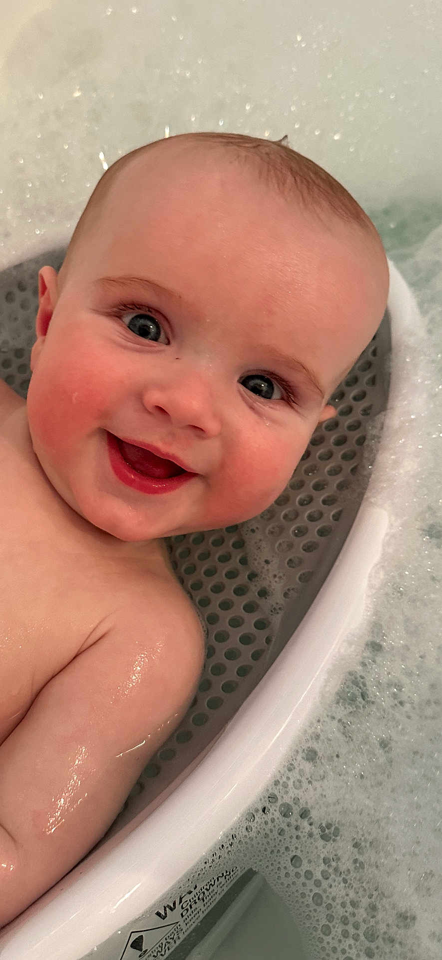 Myles is registered to the contest to win money with this photo: baby, child, smile, face, head, skin, water, bath, bathtub, bubble, foam, wet, happy, infant, person, closeup, cute, cheek, eye, indoors