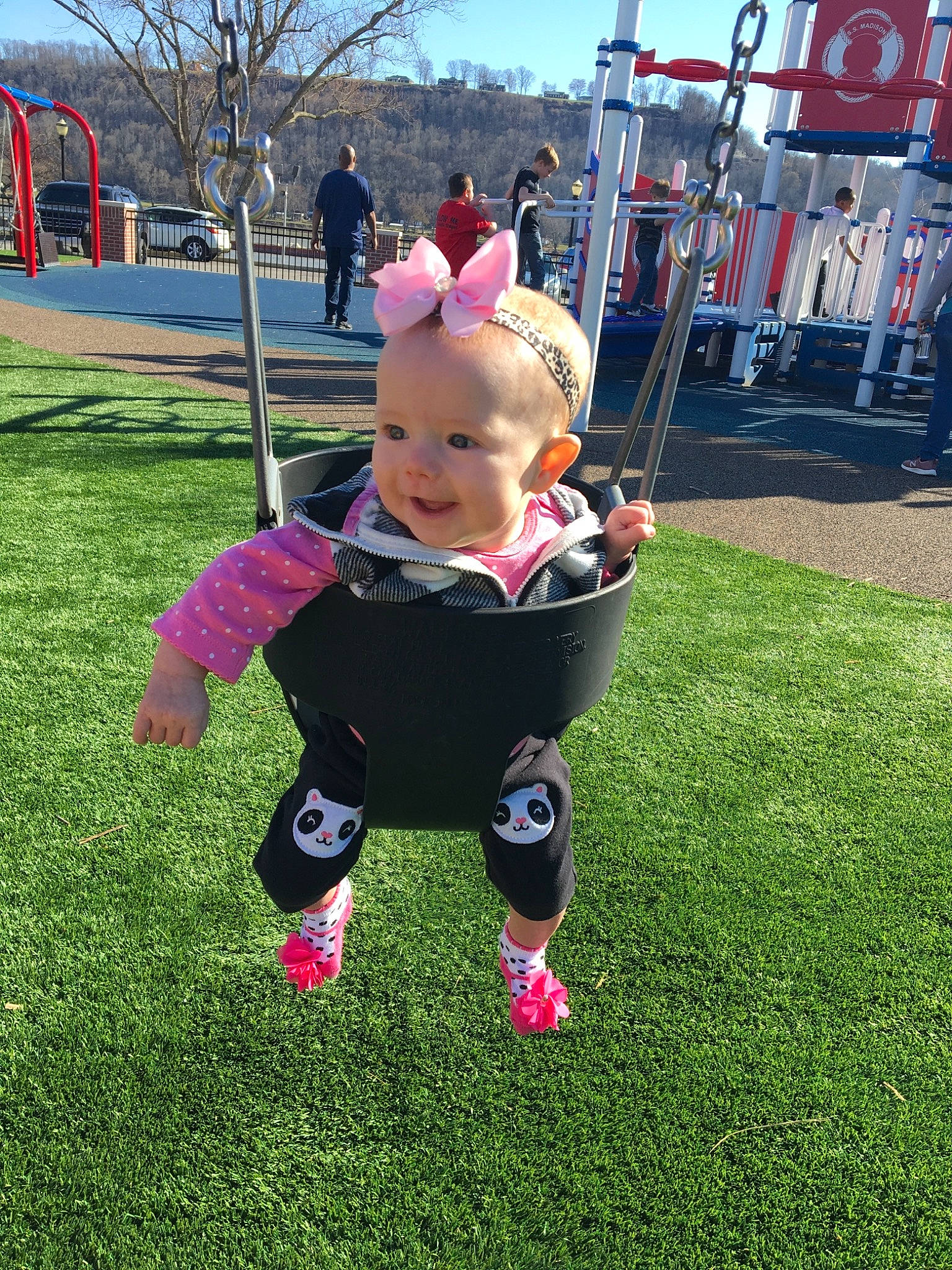 Kamilla is registered to the contest to win money with this photo: baby, child, fun, grass, lawn, outdoor_play_equipment, park, person, pink, plant, play, playground, public_space, recreation, swing, toddler, tree, vacation