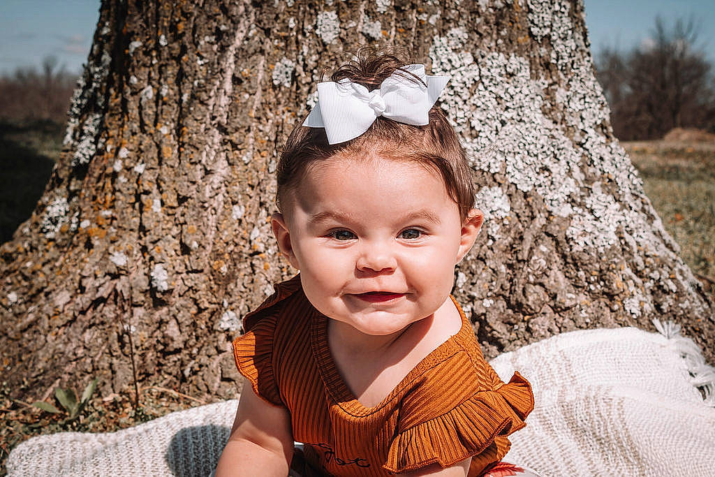 Gracelynn is registered to the contest to win money with this photo: baby, baby_toddler_clothing, beauty, child, eye, flash_photography, fun, happy, headgear, iris, leaf, people_in_nature, person, plant, skin, smile, sunglasses, toddler, tree, wood