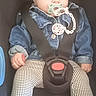 baby, child, car_seat, pacifier, headband, denim_jacket, leggings, white_shoes, safety_harness, infant, cute, seatbelt, clothing, indoor, young_child, person, portrait, fashion, accessory, baby_accessory
