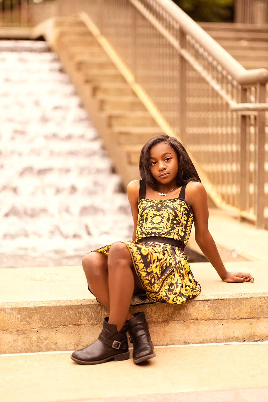 Aubrey Lauren is registered to the contest to win money with this photo: beauty, brown_hair, day_dress, fashion_design, flash_photography, footwear, fun, grass, hair, hairstyle, happy, human_leg, leisure, pattern, people_in_nature, person, sandal, sitting, thigh, waist