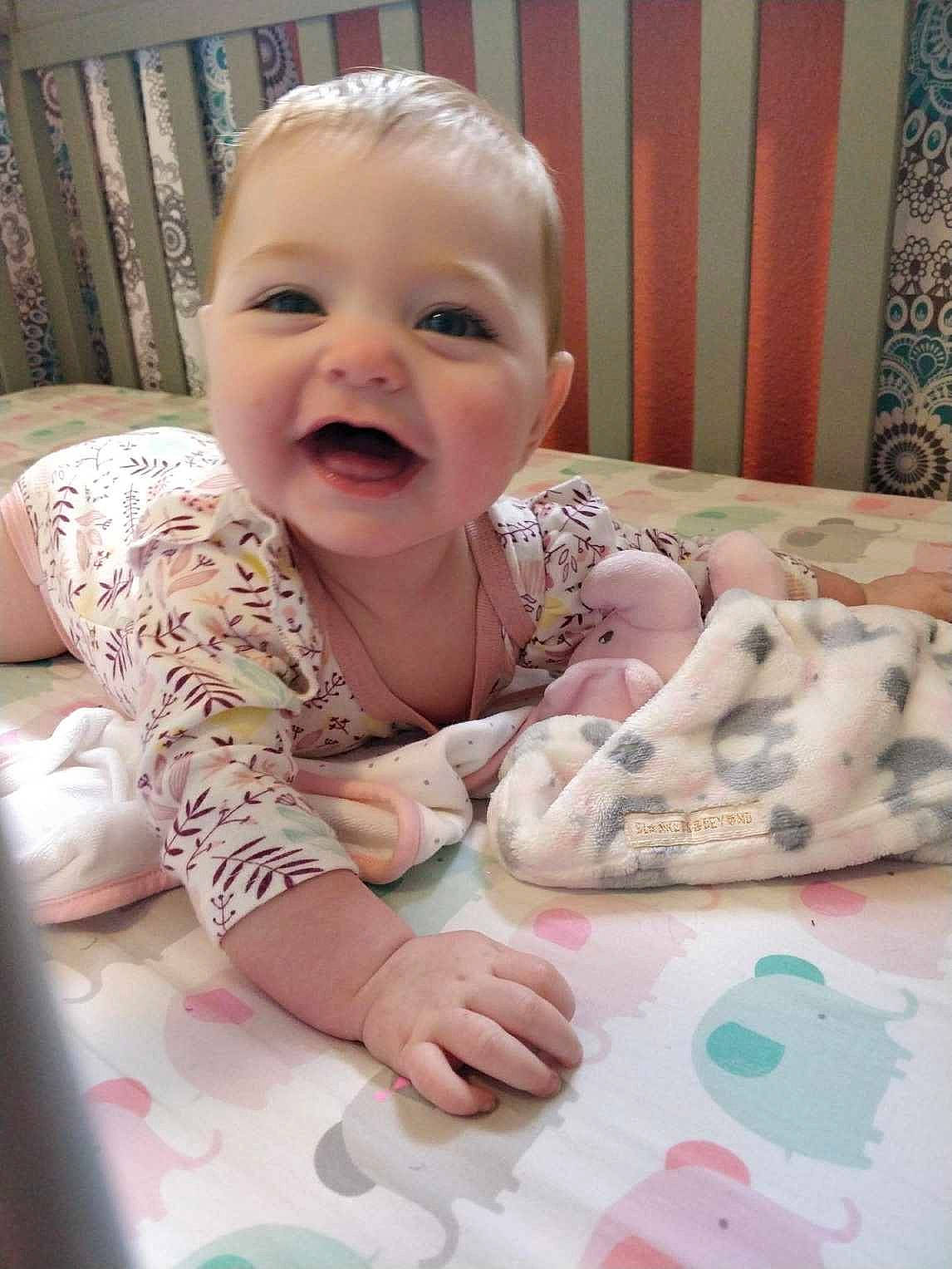 Everlee is registered to the contest to win money with this photo: baby, baby_toddler_clothing, cheek, child, comfort, dress, eye, eyebrow, facial_expression, finger, happy, head, iris, lip, mouth, nose, person, pink, skin, smile