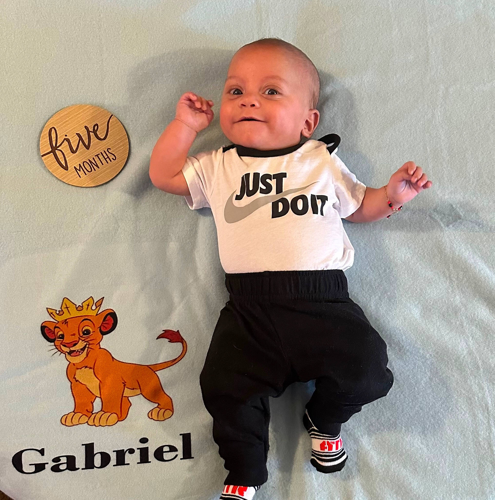Gabriel is registered to the contest to win money with this photo: baby, baby_toddler_clothing, child, dog, finger, font, happy, humour, pattern, person, photo_caption, pink, pleased, sleeve, smile, t_shirt, tail, textile, thumb, toddler