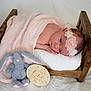 Mia-Bella is registered to the contest to win money with this photo: baby, newborn, blanket, wooden_bed, flower_headband, plush_toy, bunny, milestone_sign, one_month, sleeping, cute, infant, soft_toys, pink, white, wood, portrait, resting, indoor, baby_bed