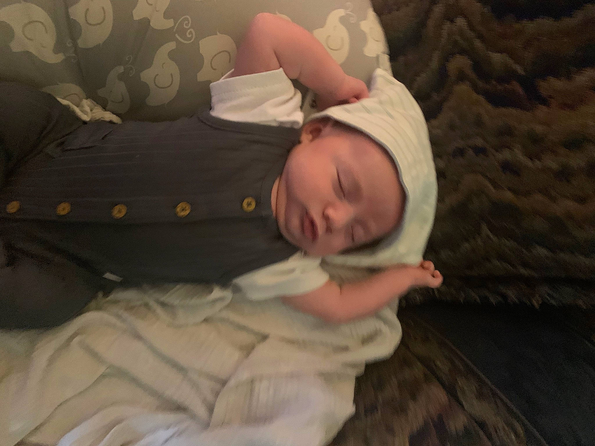 Desmond is registered to the contest to win money with this photo: baby, baby_sleeping, baby_toddler_clothing, bedding, bedtime, child, comfort, flooring, fun, headwear, linens, nap, person, room, sitting, sleep, sleeve, toddler, tree, wood