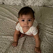 Yara is registered to the contest to win money with this photo: baby, crawling, bed, pillow, pattern, infant, child, cute, indoors, person, clothing, face, hands, eyes, drool, expression, young, sleeping_area, blanket, soft