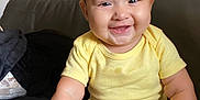 Yara is registered to the contest to win money with this photo: baby, child, smiling, yellow_onesie, sitting, couch, happy, infant, hair_tuft, indoor, skin, face, cute, portrait, small_hand, small_foot, chubby, person, young, bright_eyes
