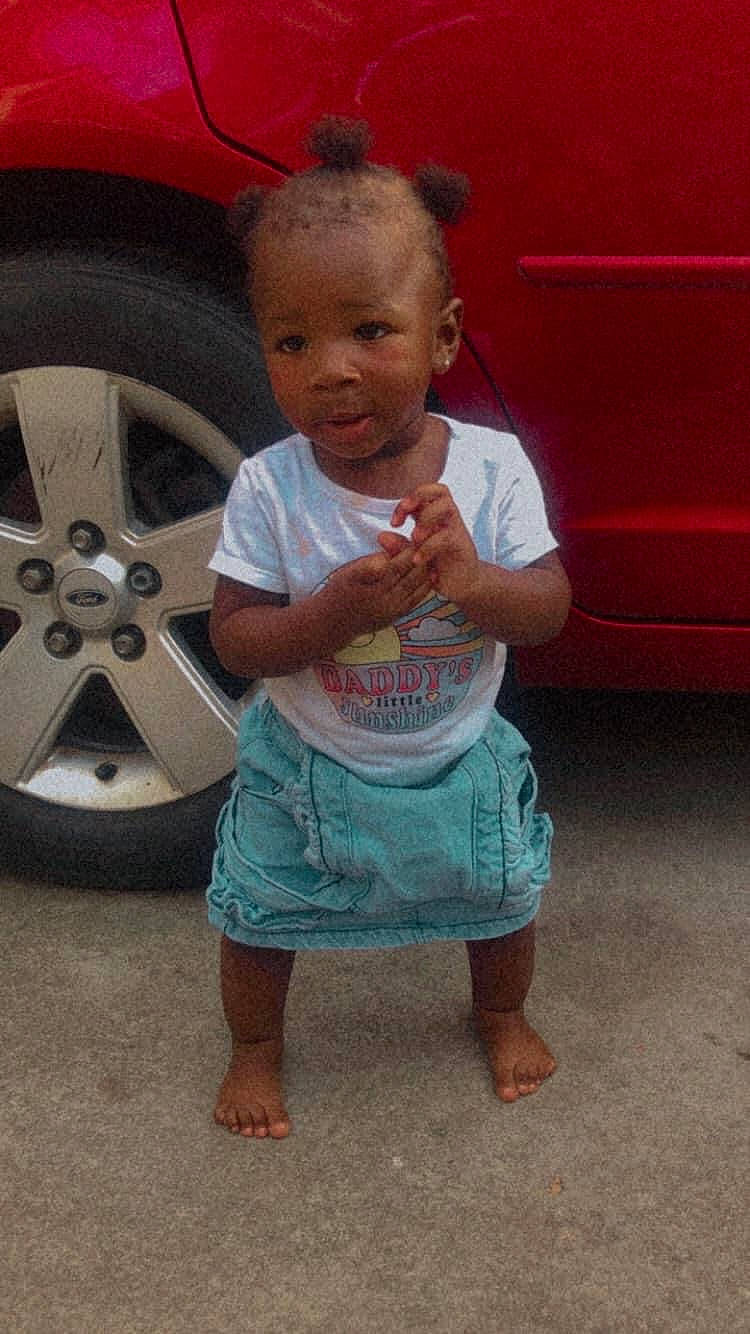 Dior is registered to the contest to win money with this photo: alloy_wheel, automotive_exterior, automotive_lighting, automotive_tire, baby_toddler_clothing, bumper, car, child, fender, hubcap, motor_vehicle, person, pink, rim, skin, tire, tire_care, toddler, tread, vehicle_door