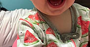 Riley is registered to the contest to win money with this photo: apparel, baby, baby_seat, cheeks, child, closeup, cute, expression, eyes, face, happy, indoor, infant, mouth, onesie, person, pink_seat, skin, smile, watermelon_pattern