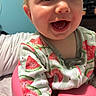 apparel, baby, baby_seat, cheeks, child, closeup, cute, expression, eyes, face, happy, indoor, infant, mouth, onesie, person, pink_seat, skin, smile, watermelon_pattern