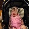 Kordova is registered to the contest to win money with this photo: baby, infant, pink_dress, headband, smiling, car_seat, striped_cushion, indoor, child, cute, happy, person, seat, clothing, young_child, expression, portrait, baby_girl, comfort, seatbelt