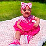 baby, child, pink, dress, headband, bow, sneakers, blanket, outdoor, grass, smiling, cute, tutu, sunny, happy, sitting, young_child, fashion, footwear, portrait