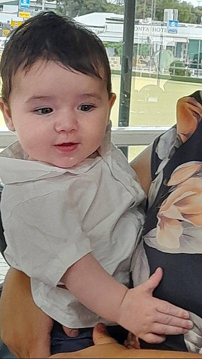 Lincoln is registered to the contest to win money with this photo: arm, baby, baby_toddler_clothing, cheek, child, comfort, elbow, facial_expression, fun, gesture, hairstyle, hand, happy, neck, person, shoulder, sitting, skin, sleeve, thumb