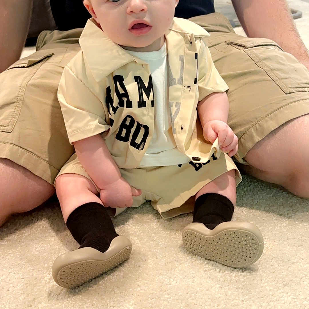 Blake Mattingly is registered to the contest to win money with this photo: baby, clothing, couch, face, footwear, furniture, head, homedecor, hosiery, pants, person, photography, portrait, shirt, shoe, shorts, sitting, sock, t_shirt, toy