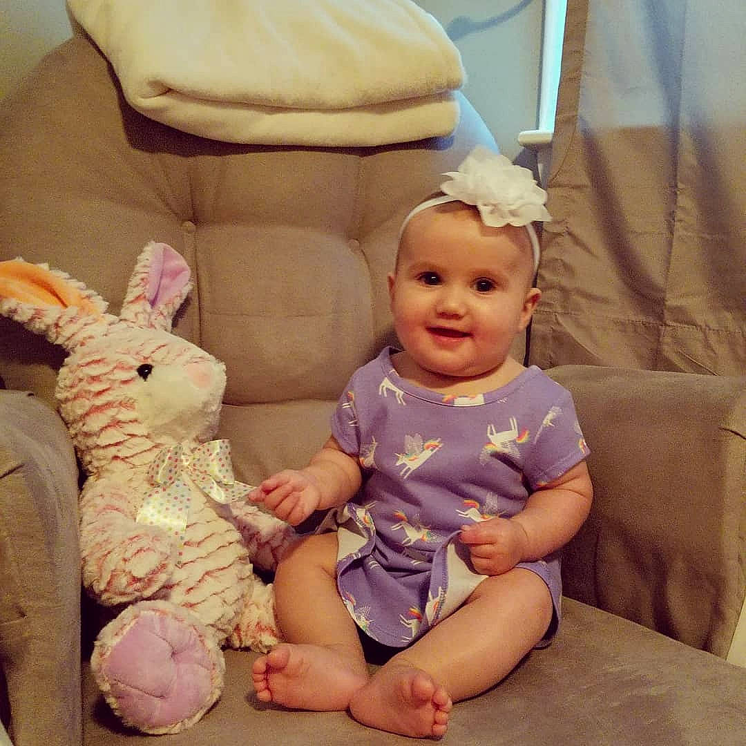 Rosie is registered to the contest to win money with this photo: baby, child, ear, joy, person, pink, play, room, sitting, toddler, toy