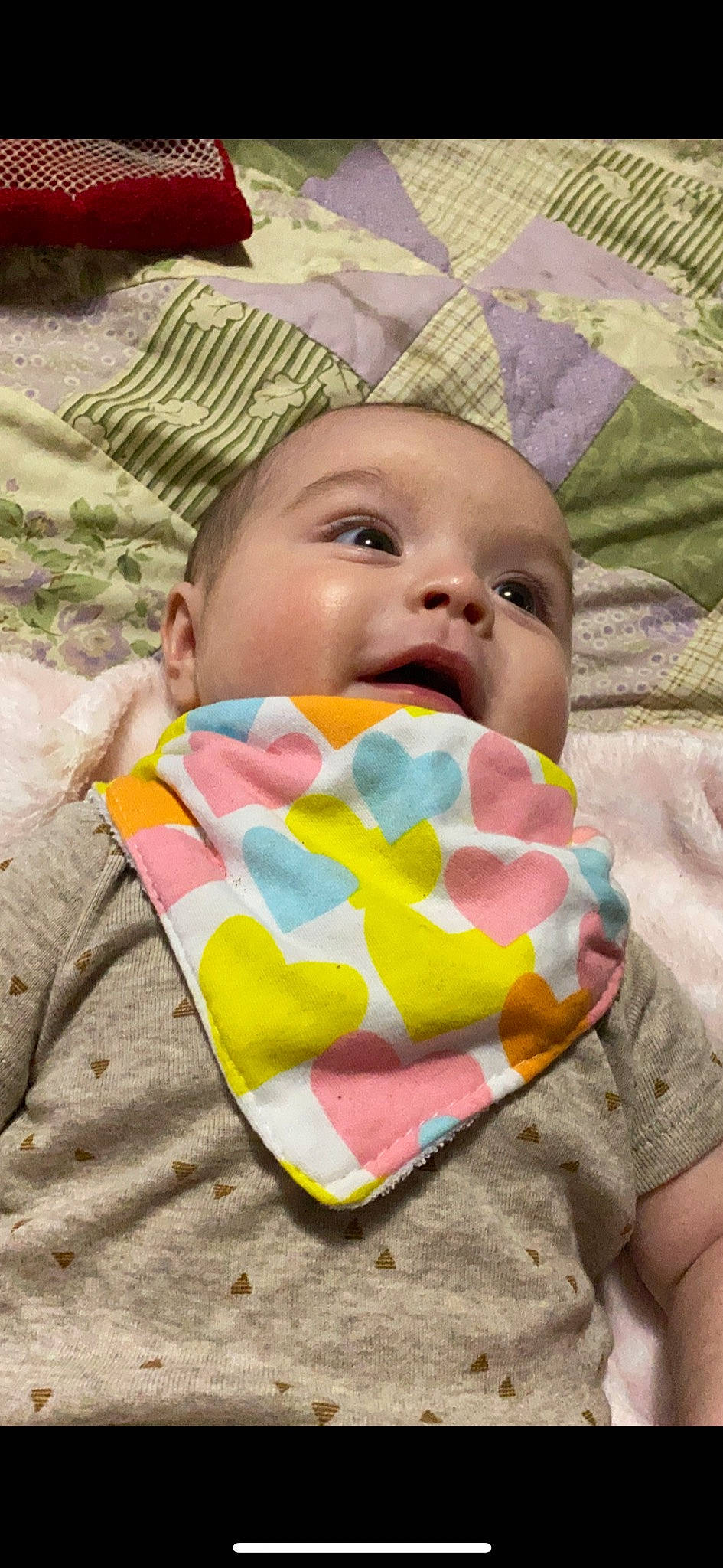 Ailani joined the competition — help win amazing prizes! baby, baby_toddler_clothing, bib, cheek, child, comfort, cool, eyelash, facial_expression, fun, happy, headgear, linens, mouth, nose, pattern, person, pink, skin, sleeve