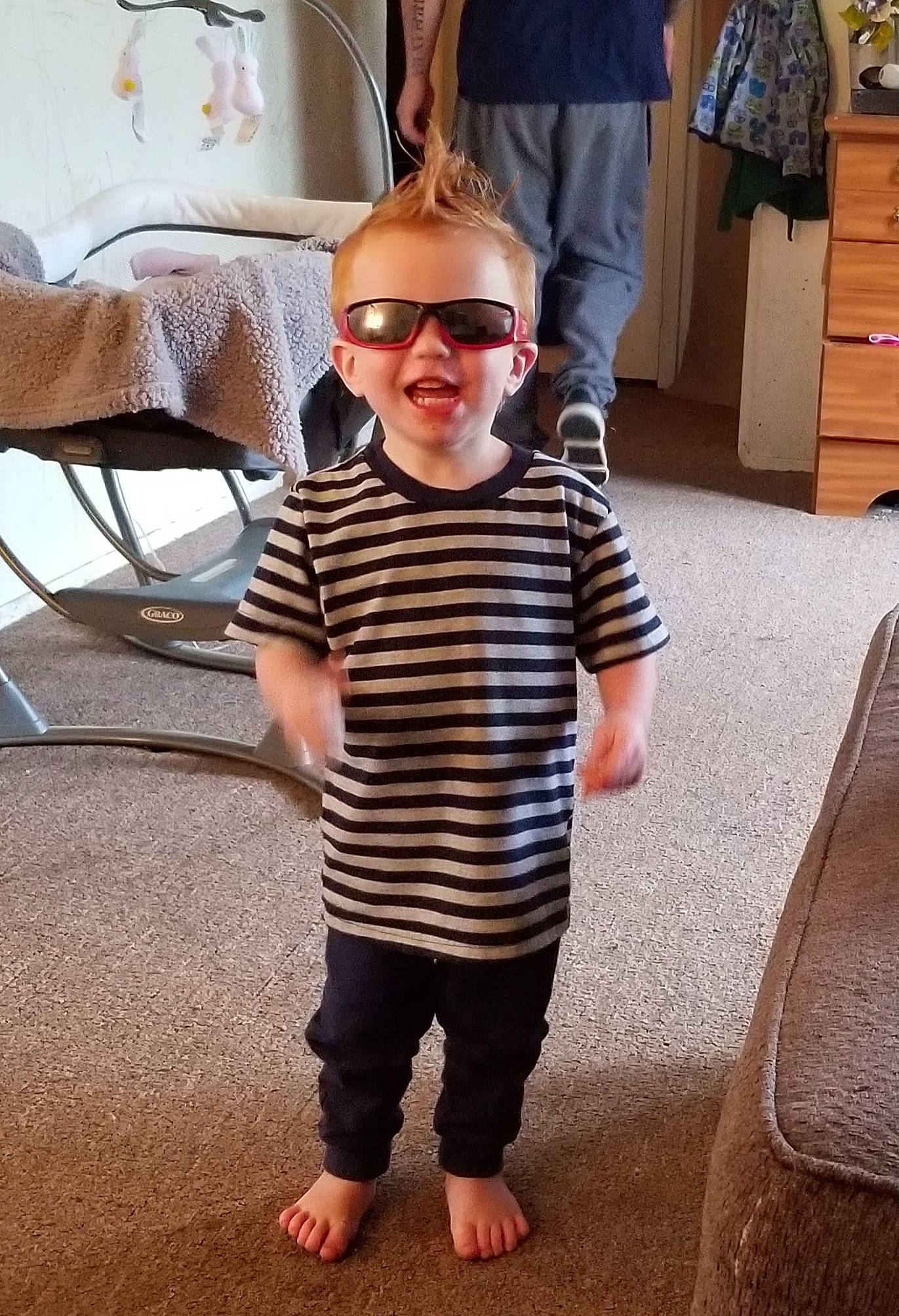Chase is registered to the contest to win money with this photo: arm, child, cool, day, eyewear, footwear, fun, glasses, headwear, jeans, leg, outerwear, person, product, shoulder, sleeve, standing, sunglasses, t_shirt, textile