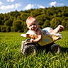 baby, blue_sky, child, clouds, diaper, field, grass, grass_field, greenery, happy, infant, nature, outdoor, play, portrait, rusty, summer, sunlight, toy_truck, vehicle