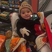Mylow a rejoint le concours — aidez-le/la à gagner de superbes lots ! aisle, baby, blanket, child, clothing, cute, face, food, footwear, groceries, grocery_store, hat, indoor, mickey_mouse, person, retail, shopping, shopping_cart, smile, sweater