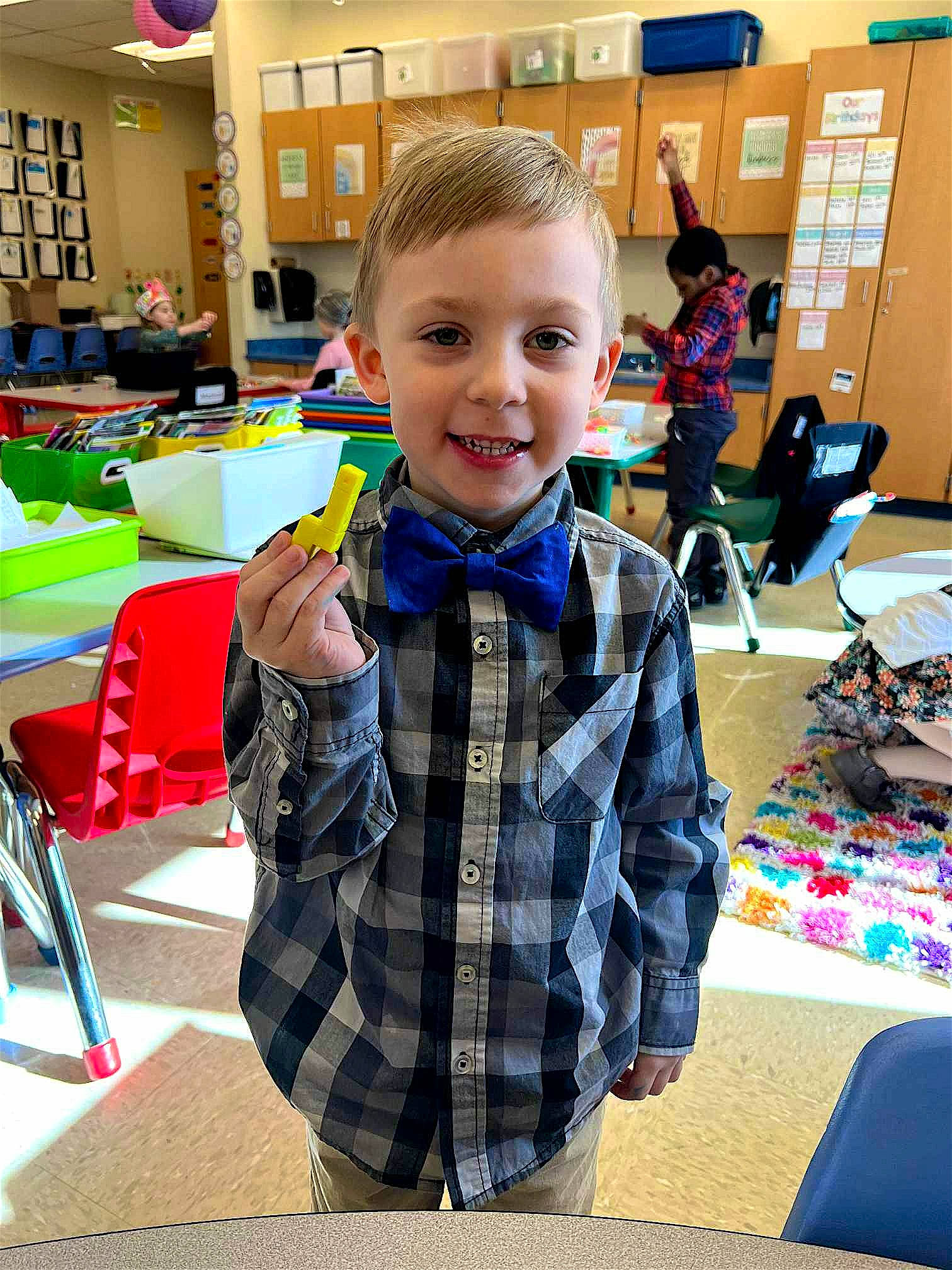 Ryker is registered to the contest to win money with this photo: chair, child, community, design, engineering, event, flooring, fun, happy, kindergarten, leisure, pattern, person, plaid, play, recreation, smile, table, tartan, toddler