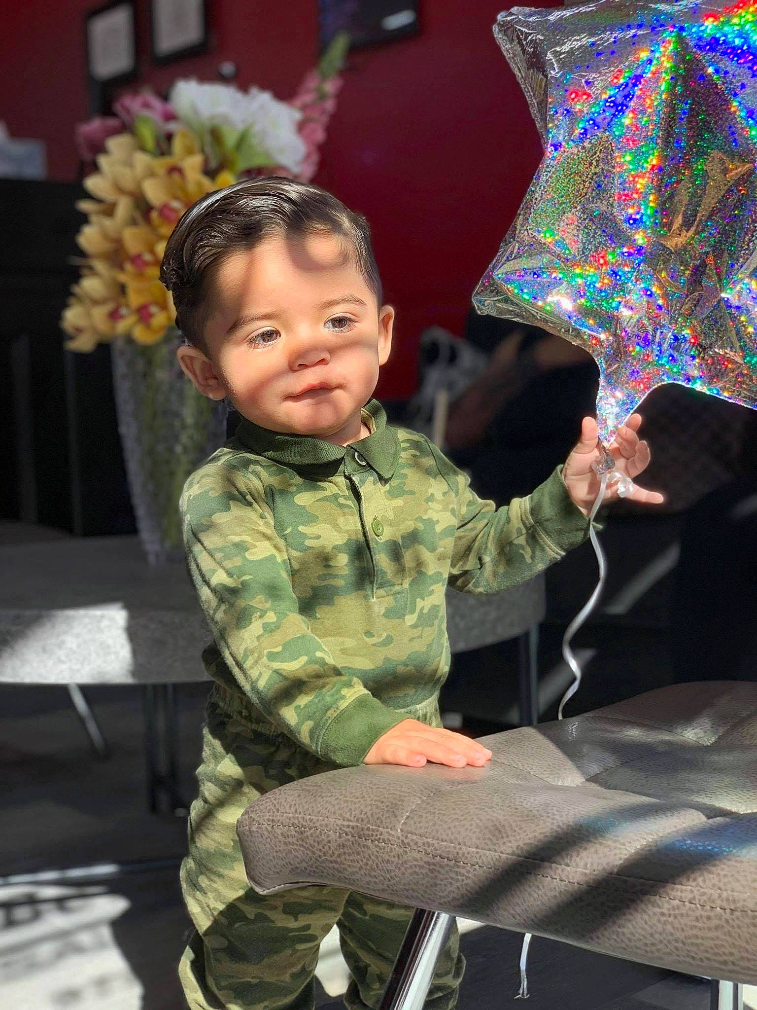 Lionel joined the competition — help win amazing prizes! chair, child, costume, event, fashion, fashion_accessory, flower, fun, holiday, human, military_camouflage, military_person, military_uniform, non_commissioned_officer, pattern, person, sitting, standing, toddler, tradition