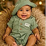 baby, bokeh, buttoned_shirt, child, cozy, cushion, cute, face, fluffy, green_clothing, happy, hat, headwear, indoors, infant, portrait, sitting, skin, smiling, warm_lighting