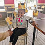 He'Liey joined the competition — help win amazing prizes! child, burger_king, crown, restaurant, indoor, table, chair, playful, tongue_out, smiling, person, clothing, window, daylight, floor, tile_floor, hand, sneakers, black_pants, long_sleeve_shirt