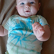 Landry joined the competition — help win amazing prizes! baby, infant, onesie, blue_eyes, tie_dye, blanket, soft_texture, cute, lying_down, hand, skin, cheeks, child, happy, portrait, indoor, apparel, person, newborn, smiling