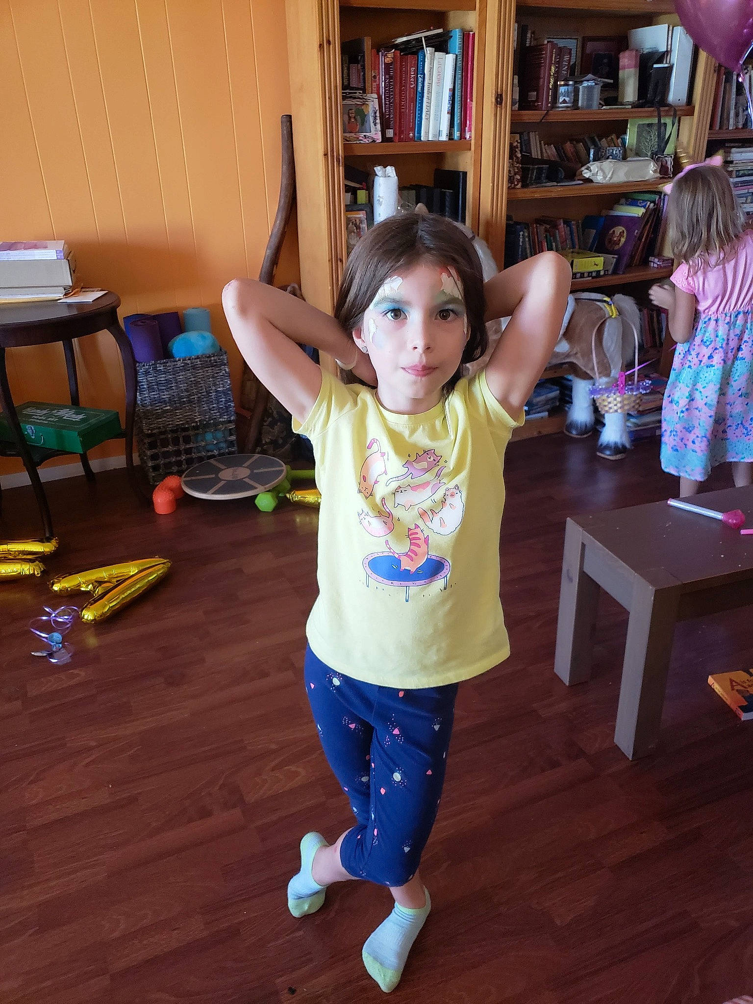 Kinsey joined the competition — help win amazing prizes! bookcase, floor, flooring, fun, happy, hardwood, human_leg, joint, laminate_flooring, leisure, person, shelf, shelving, standing, table, thigh, toddler, varnish, waist, wood