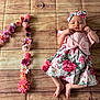 Victoire participe au concours pour gagner de l'argent avec cette photo : adorable, baby, baby_girl, celebration, child, cute, floral_dress, flower_arrangement, headband, infant, lying_down, milestone, newborn, number_one, pattern, pink, portrait, small_feet, soft_lighting, wooden_floor_pattern