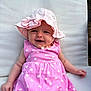 Victoire participe au concours pour gagner de l'argent avec cette photo : apparel, baby, baby_girl, child, cushion, cute, flower_pattern, happy, hat, headwear, infant, outdoor, person, pink_dress, portrait, sitting, smiling, summer, sun_hat, young_child