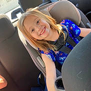 Amarah joined the competition — help win amazing prizes! child, girl, car_seat, smiling, blue_dress, butterflies, seatbelt, car_interior, sunlight, toy, plush_toy, happy, young, seat, vehicle, child_safety, casual, daylight, backseat, portrait