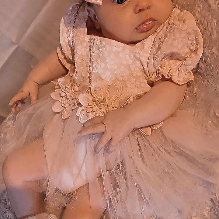 Aubrey is registered to the contest to win money with this photo: baby, bodypart, bonnet, clothing, doll, dress, eveningdress, face, fashion, finger, formalwear, gown, hand, hat, head, lace, person, photography, portrait, toy