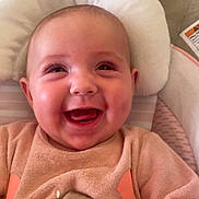 Leyna participe au concours pour gagner de l'argent avec cette photo : baby, smiling, infant, cute, cozy, pink_clothing, cushion, seat, happy, child, face, portrait, closeup, soft_texture, indoor, person, baby_seat, clothing, comfort, joy