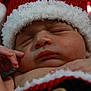 baby, blanket, button, christmas, closeup, cozy, cute, face, hand, hat, holiday, infant, knitted, peaceful, portrait, red, santa_hat, skin, sleeping, white