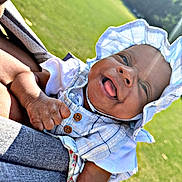 Coreyanna joined the competition — help win amazing prizes! baby, child, infant, hat, sunhat, outdoor, grass, smiling, tongue_out, plaid_clothing, person, cute, happy, daylight, nature, portrait, baby_clothes, hand, headwear, holding