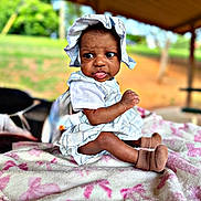 Coreyanna is registered to the contest to win money with this photo: baby, child, infant, hat, socks, blanket, outdoor, nature, grass, picnic, bench, expression, tongue, curious, portrait, sitting, clothing, person, sunhat, daylight
