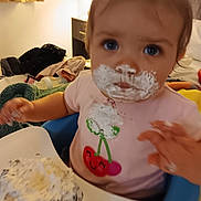 Arya joined the competition — help win amazing prizes! baby, blue_eyes, child, clothing, cream, cupcake, cute, dessert, expression, face, food, hands, high_chair, indoor, messy, person, pink_shirt, smudged, table, toddler