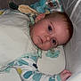 baby, crib, sleeping_sack, plush_toy, pacifier, infant, child, bed, sleepwear, person, face, resting, indoors, cute, young, soft, blanket, comfort, lying_down, toddler