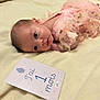 Maïwenn a rejoint le concours — aidez-le/la à gagner de superbes lots ! baby, baby_girl, blanket, blue_eyes, card, closeup, cute, face, frills, indoor, infant, lying_down, milestone, newborn, one_month, pink_clothing, portrait, resting, soft_lighting, soft_texture