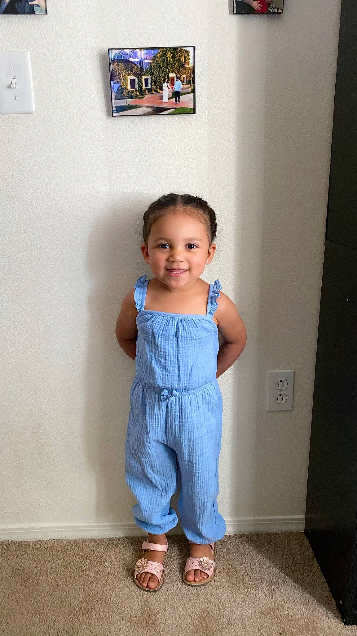 Aria is registered to the contest to win money with this photo: baby, baby_toddler_clothing, blue, child, clothing, denim, dress, joy, one_piece_garment, overall, pattern, person, room, smile, standing, toddler