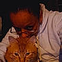 Pretty Boy joined the competition — help win amazing prizes! person, cat, orange_tabby, glasses, hoodie, indoor, close_up, pet, affection, face, eyewear, animal, domestic_cat, comfort, warm_lighting, cuddling, portrait, feline, nighttime, casual