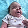 Shai joined the competition — help win amazing prizes! baby, infant, smiling, onesie, clothing, blanket, blue, crown_pattern, fist, face, skin, cute, lying_down, happy, child, newborn, portrait, soft_texture, indoors, person