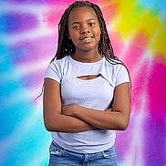 Alivia joined the competition — help win amazing prizes! child, girl, braided_hair, smile, arms_crossed, blue_jeans, purple_tie_dye_background, colorful_background, portrait, casual_clothing, standing, confident, young_person, happy, fashion, studio_photo, vibrant_colors, cool_tone, youth, positive