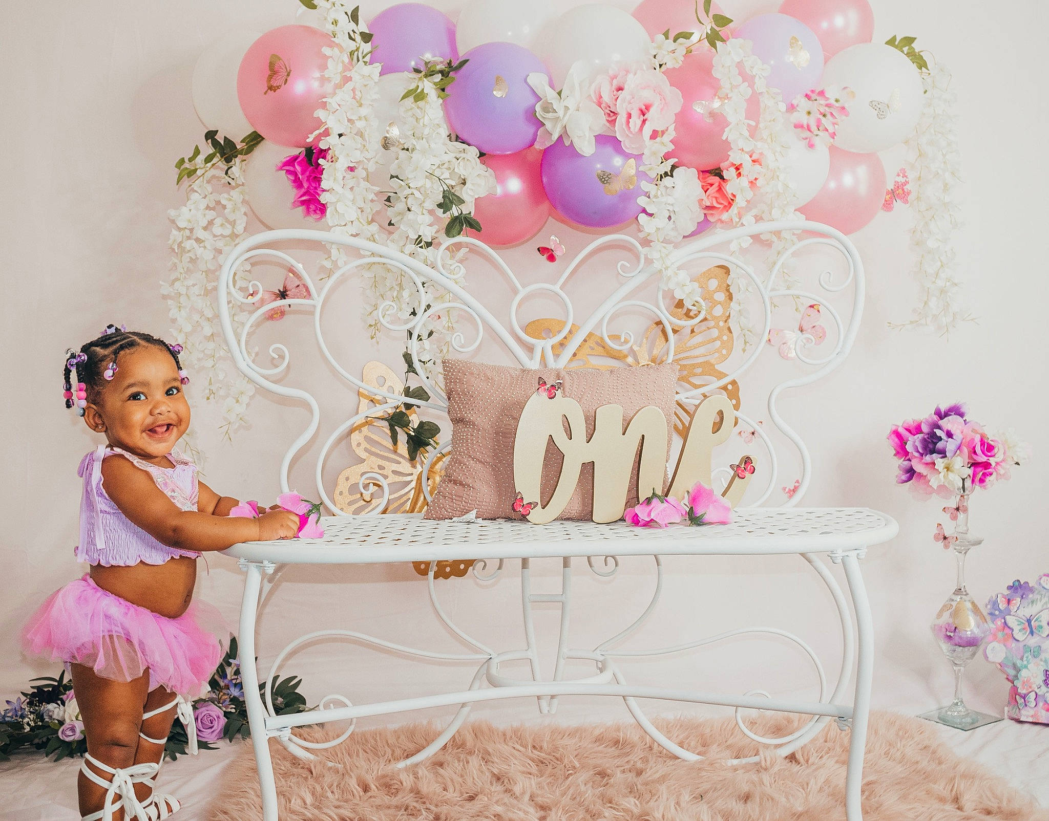 Déhlaní is registered to the contest to win money with this photo: baby_toddler_clothing, child, decoration, event, fashion_accessory, font, happy, headpiece, joy, magenta, party_supply, pattern, peach, person, petal, pink, plant, smile, table, textile