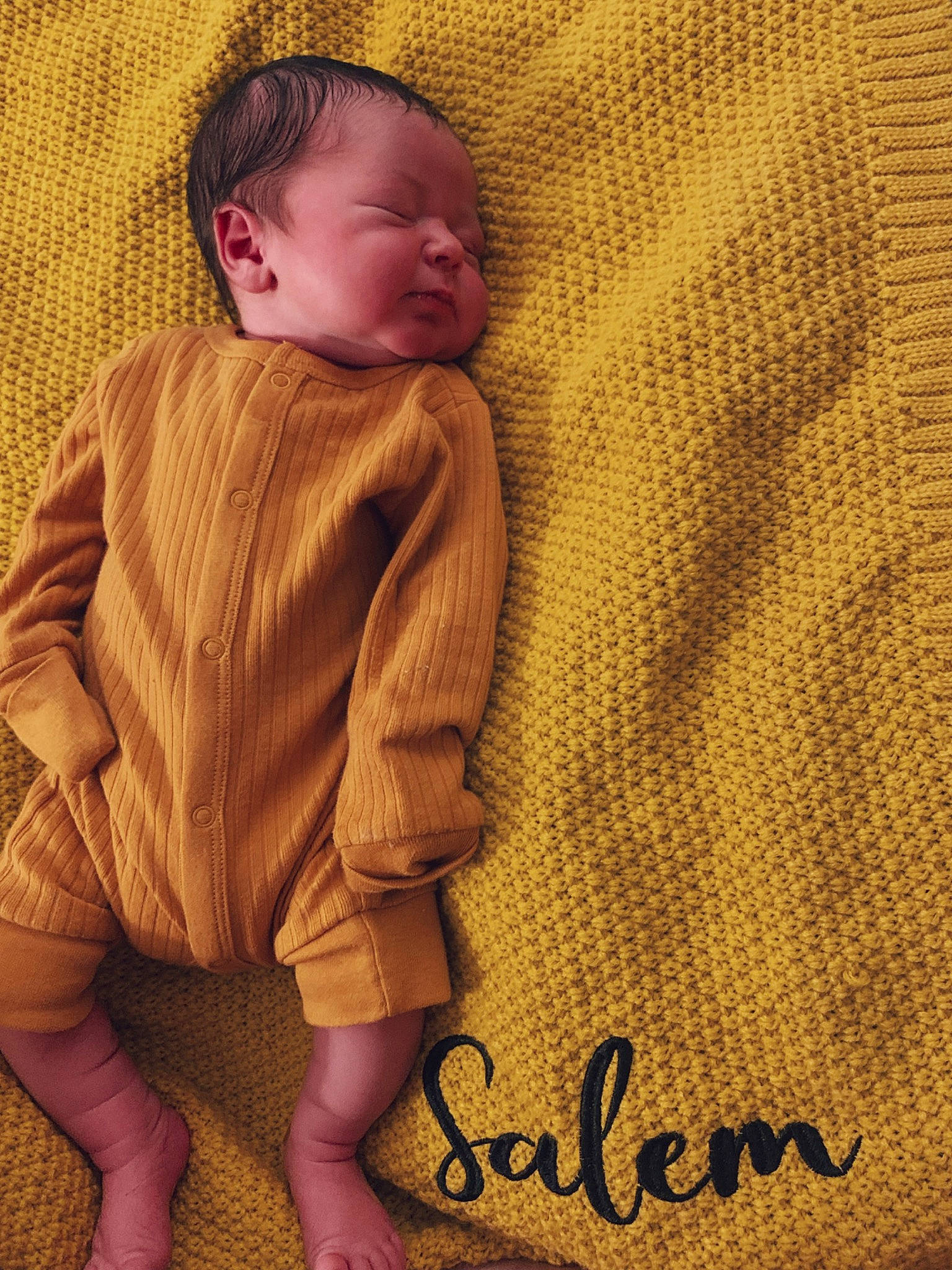 Salem is registered to the contest to win money with this photo: baby, baby_toddler_clothing, child, comfort, face, finger, flooring, happy, head, headgear, linens, neck, outerwear, pattern, person, skin, sleeve, t_shirt, textile, toddler