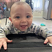 Raeleigh is registered to the contest to win money with this photo: baby, child, smile, happy, indoor, face, hands, curtain, fan, refrigerator, floor, clothing, person, infant, toy, window, home, eyes, mouth, expression