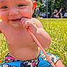 baby, bare_chest, blurred_background, chewing, child, closeup, colorful, cute, daylight, grass, happy, nature, outdoor, park, person, playful, shorts, straw, summer, sunny