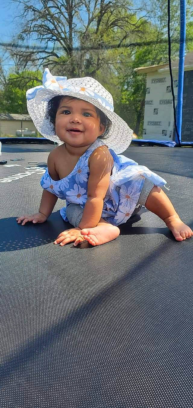 Mep is registered to the contest to win money with this photo: asphalt, blue, cap, child, electric_blue, flooring, fun, grass, happy, hat, headwear, joy, leg, leisure, person, plant, sitting, smile, sneakers, summer